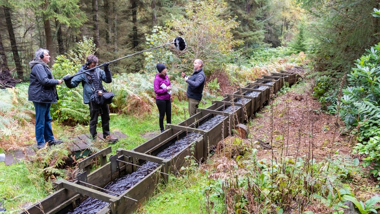 A group of people outdoors making a hydro podcast recording at Cragside, Northumberland